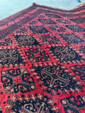 Sturdy low-pile Afghan rug featuring handwoven geometric medallions.