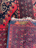 Underside view of antique Afghani rug with lattice layout and multi-band borders.