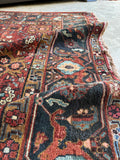 Antique Persian Heriz rug highlighting turtle motif border design.