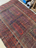 Overhead view of full 6x10 Baluch rug showing symmetry and pattern rhythm.