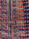 Section of Baluch rug field featuring alternating warm and cool colors.