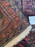 Underside view of antique Persian Baluch rug.