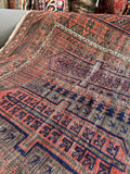Close-up of Baluch rug border with geometric grid design symbolizing protection.