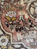 Soft goldenrod, apricot, and peach tones blending across the Tabriz field.
