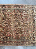 Warm goldenrod details highlighting the artistry of this antique Tabriz.