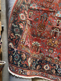 Corner view of Persian Heriz rug woven with vegetable dyed wool in warm and cool tones.