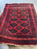 Clean and well-preserved mid-century Afghani tribal rug with bold color contrast.