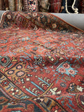 Heriz rug showing floral and geometric border patterns.