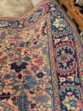 Hand knotted Persian Heriz rug close up view highlighting vibrant indigo, denim blue, and sage green accents.