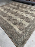 10x11 neutral Persian Shiraz rug. Antique hand knotted wool rug with repeating geometric medallions on a warm oatmeal field.