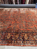 11x21 antique Persian estate rug with floral garden design and indigo border.
