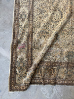 Corner detail showing faded blues and intricate motifs.