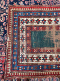 Collector antique Kazak rug without central medallion on narrow green ground.