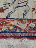 Collectible Persian textile art rug  highlighting low-pile surface texture, rich vegetable-dyed colors, and a deer motif in the border.