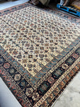 Handwoven Persian rug with floral lattice pattern