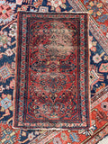 Hand-knotted Lilihan area rug woven by a female artisan in the 1920s with organic floral sprays.