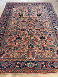 1920s antique Heriz area rug navy border detail with multi-colored floral motifs and natural dyes.