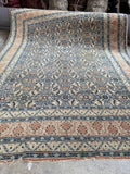 Heavy duty Persian entry rug flat layout against neutral background illustrating durable pile texture.