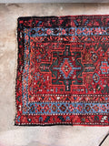 Bold tribal art Persian runner captured in natural light to emphasize its historic character and warmth.