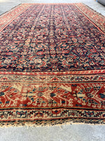 Handwoven Persian rug with vegetable dyed wool in navy, rust, and ivory tones.