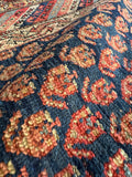 Authentic hand knotted paisley runner rug featuring symbolic flame of life motifs.