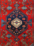 Close-up of graphic central medallion with a  navy ground.
