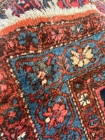 Close up view of a 1920s Malayer rug with some wool loss.