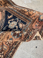 Antique Persian rug with animals, fish, and floral border design and an underside view.