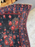 Corner detail showing the floral border and rich colors of the Bidjar rug.