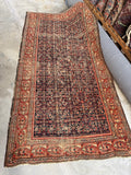 Antique 1920s Persian rug handwoven with vegetable dyed wool and Herati motif on navy blue ground.