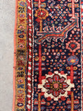 Antique Persian Area Rug handmade 1920s Heriz with bold tribal design, angular motifs, and professionally reinforced edges.