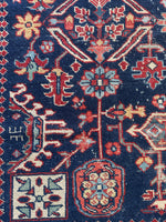 Close-up of stylized botanical motif on navy blue ground.