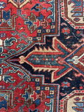 Antique Persian rug 10x13 Heriz style with a vibrant color palette.