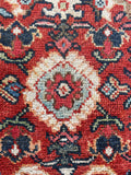 1920s Persian Mahal rug detail with intricate floral elements and color variation.