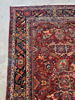 Corner of a Mahal rug with decorative border detail.