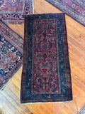 1920s Persian Malayer rug featuring saturated vegetable dyed wool and floral village motifs.
