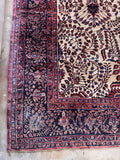 Vegetable-dyed Persian Sarouk wool rug corner detail showing the heavy woven structure and outer guard borders.