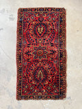 1920s Persian Sarouk wool rug with a dense hand-knotted pile.