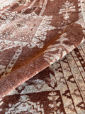 Brown and beige small area rug featuring traditional octagonal rosettes and floral medallion patterns.