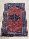 Vintage Persian Malayer rug with tribal village motifs and saturated jewel toned colors in red and navy blue.