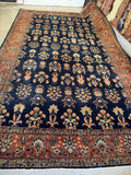 Oversize 1920s Sarouk rug measuring 10'5 x 17' with spacious palmette motifs.