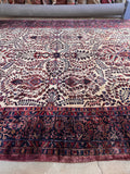 1920s Sarouk Persian wool rug wide angle view demonstrating how the allover floral pattern flows seamlessly across the field.