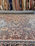 Oversized Persian Mahal rug detail displaying timeworn distress and natural foundation showing through.