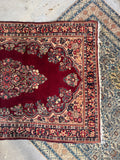 Reinforced antique Persian wool rug close up showing clean edge finish and durable heavy structure.