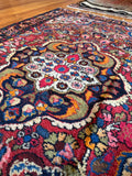 Vintage Persian Dargazin rug featuring electric blue, raspberry red, and tangerine accents.