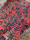 Handwoven 1930s Persian Sarouk rug displaying dense wool construction and low pile.