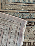 Thick wool texture and durable construction on early 1900s Seraband rug.