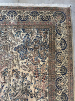 1940s Persian rug with bird and floral border on ivory field.