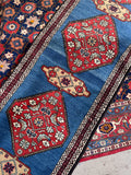 Skinny antique Persian hallway runner in French blue with red floral medallions.