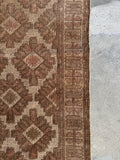 Vintage tribal runner with whimsical border design detail.